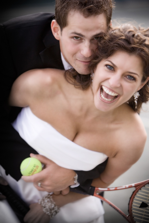 Adorable bride and groom with tennis raquet and ball - wedding photo by J Garner Photographer